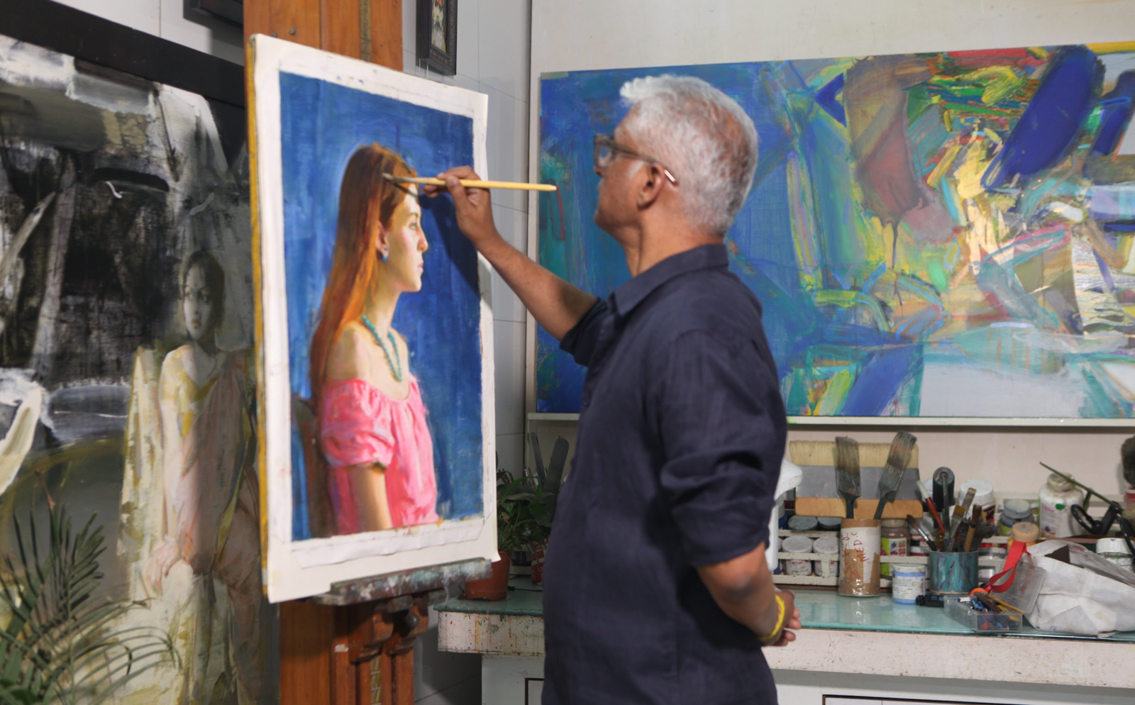 Mentor demonstrating painting with student